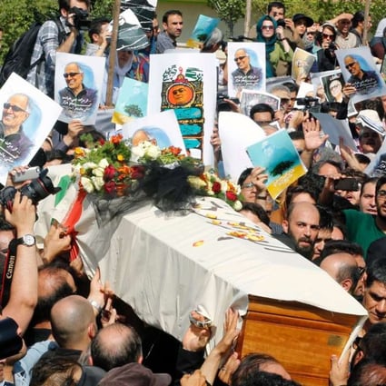 Mourners carry the coffin of Abbas Kiarostami on July 10 in the Iranian capital ahead of his funeral in the town of Lavasan. Photo: AFP