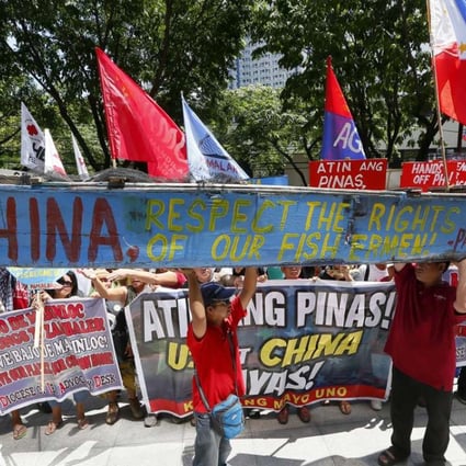 Protesters display a broken fishing boat with a message during a rally outside of the Chinese Consulate hours before the Hague-based UN international arbitration tribunal is to announce its ruling on South China Sea. Photo: AP