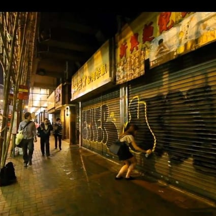 American graffiti artist Utah spray-paints at an unknown location in Hong Kong.