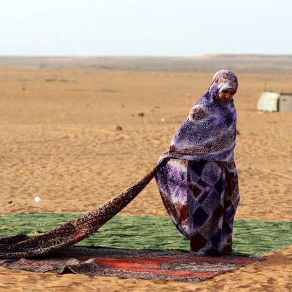 A Sahrawi refugee stands on a rug at the Sahrawi refugee camp of Dakhla, in the disputed territory of Western Sahara. Photo: AFP
