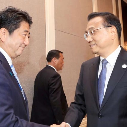 Premier Li Keqiang, right, meets Japanese Prime Minister Shinzo Abe on the sidelines of the Asem Summit in Ulan Bator on Friday. Photo: Kyodo