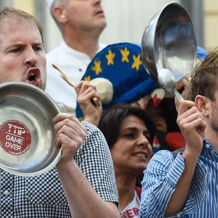 Activists bang on pans during a protest against the Transatlantic Trade and Investment Partnership in front of the EU commission building in Brussels on July 12, 2016. Photo: AFP