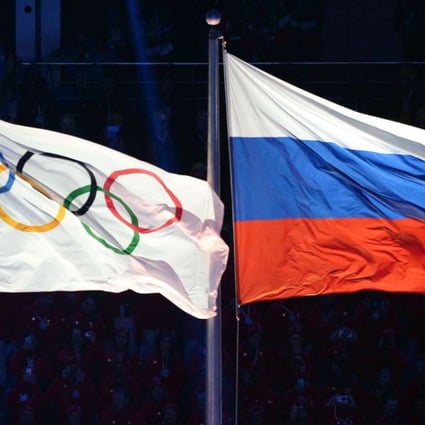 This file photo taken on February 7, 2014 shows the Olympic and Russian flags during the Opening Ceremony of the Sochi Winter Olympics. AFP