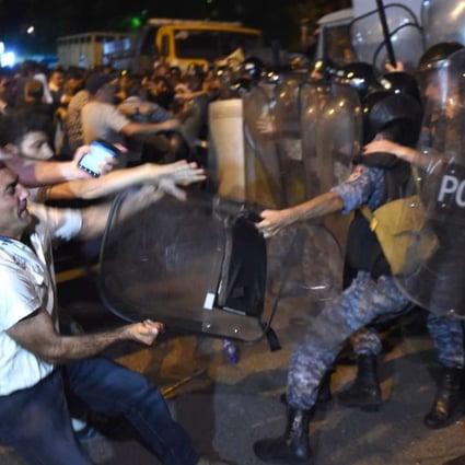 Protesters clash with police near a police station that was seized on 17 July in Yerevan, Armenia. Photo: EPA