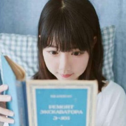 Portraits of a young woman reading a manual for an old Russian excavator have brought her instant fame online. Photo: SCMP Pictures