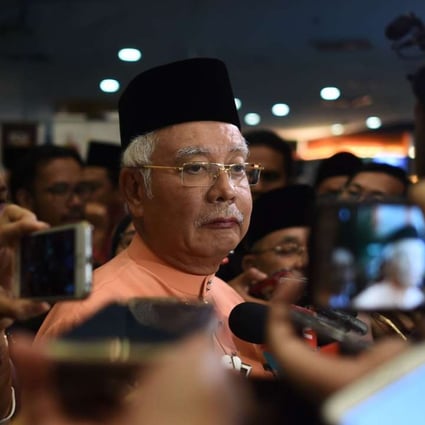 Malaysian Prime Minister Najib Razak is quizzed by reporters after an event in Kuala Lumpur on Thursday, a day after Singapore said it had seized nearly US$180 million linked to scandal-tainted state fund 1MDB. Photo: AFP
