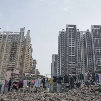 -- STRICTLY ONE TIME USE ONLY-- This image, taken by Matjaz Tancic shows laundry being aired over rubble and in front of new apartments Guangzhou. 03APR14 [12APRIL2015 FEATURE 1 POST MAGAZINE] --LEAD IMAGE--