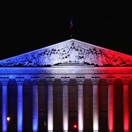The French National Assembly's palais Bourbon in Paris illuminated in the French flag colours in tribute to the victims of the attack in the Normandy city of Saint-Etienne-du-Rouvray. Photo: AFP