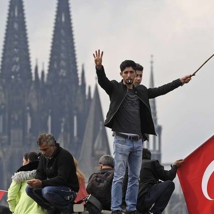 Turkish protesters demonstrate in Cologne, Germany, on Sunday in support of Turkish President Recep Tayyip Erdogan. Photo: AP