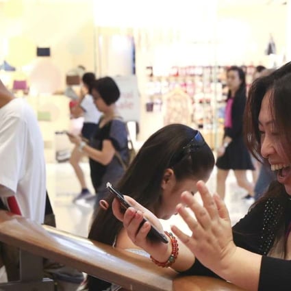A happy customer playing Pokemon Go at Olympian City in West Kowloon. Shopping mall owners in Hong Kong are having to come up with creative ways of attracting more visitors, as numbers from the mainland continue falling. Photo: Sam Tsang