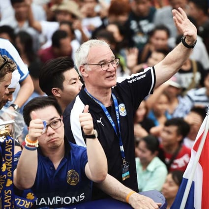 Leicester City football manager Claudio Ranieri waves to Thai supporters during an open-bus parade in Bangkok to celebrate his side winning the English Premier League. The club is owned by Thai billionaire Vichai Srivaddhanaprabha. Photo: AFP
