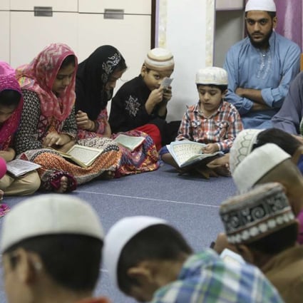 Muslim children packed into a small space in San Po Kong for afternoon prayers. Photo: K.Y. Cheng