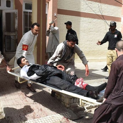 Pakistani volunteers use a stretcher to move an injured lawyer after the suicide bomb in Quetta. The regional arm of Islamic State claimed responsibility for the attack. Photo: AFP