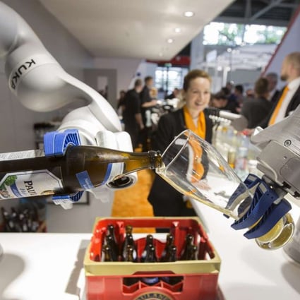 A Kuka-made industrial robotic arm pours a glass of beer at a trade fair in Munich on June 21. Midea stands to directly benefit from Kuka’s Industry 4.0 expertise and its vast foreign network. Photo: Bloomberg
