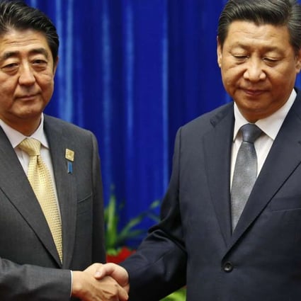 President Xi Jinping shakes hands with Japanese Prime Minister Shinzo Abe at their meeting on the sidelines of the Apec summit in Beijing in November 2014. Photo: Reuters