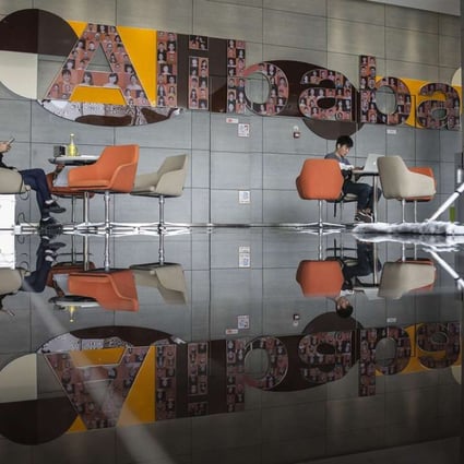 An employee mops the floor in a building lobby at the Alibaba Group Holding Ltd. headquarters in Hangzhou, China, on Tuesday, Oct. 13, 2015. Alibaba's bet on data technology is driving greater investment in areas including ways to protect user privacy as it battles Amazon.com Inc. for customers globally. Photographer: Qilai Shen/Bloomberg ORG XMIT: 585718101
