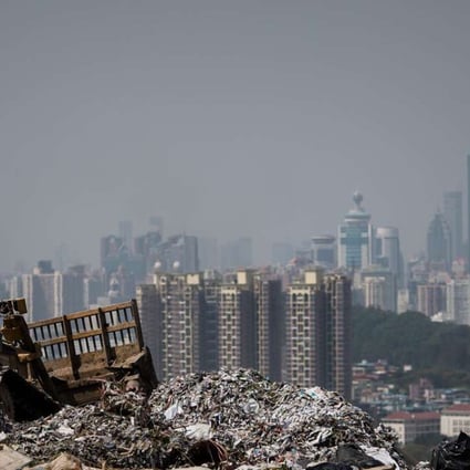 Shenzhen tower blocks loom over a landfill in the New Territories, Hong Kong. Nearly 40 per cent of the city’s municipal solid waste is composed of food. Photo: AFP