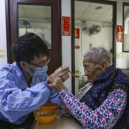 Personal care worker assisting an elderly resident to eat. Photo: Jonathan Wong