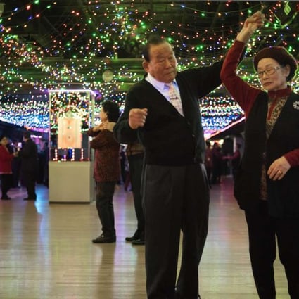 An elderly Korean couple dance inside the Kukilgwan Palace in Seoul. Pension funds in the country are looking at how to achieve better returns in today’s low interest-rate environment. Photo: AFP