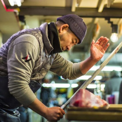 A worker slices tuna in a still from the documentary film Tsukiji Wonderland.