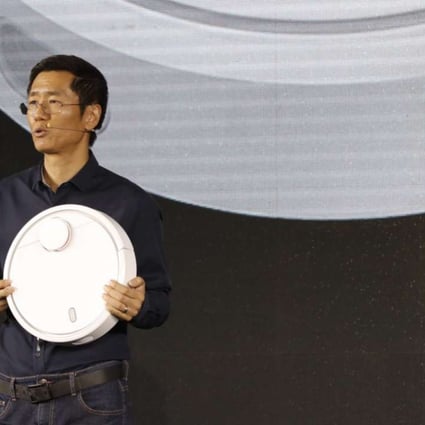 Xiaomi co-founder and vice president Liu De introduces the features of the Mi Robot Vacuum in Beijing on Wednesday. Photo: Xiaomi