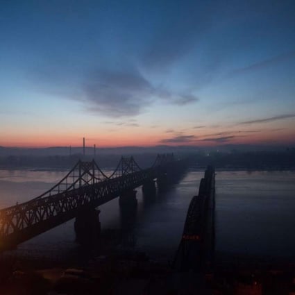 The sun rises over the bridge that connects the Chinese border town of Dandong with the North Korean town of Sinuiju. Krys Lee’s novel looks at the experiences of those who flee North Korea. Photo: AFP