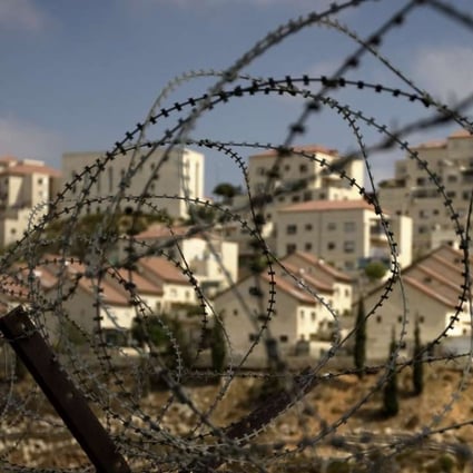 A Jewish settlement in the West Bank, seen through a barbed wire fence. Milton Viorst’s book grapples with how Israel got itself into its current position. Photo: AP