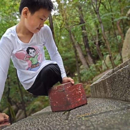 Chinese boy Gao Zhiyu, 11, climbed 900 metres up Mount Lao, in China’s eastern Shandong province, before having to stop because of severe blister. Photo: SCMP Pictures.
