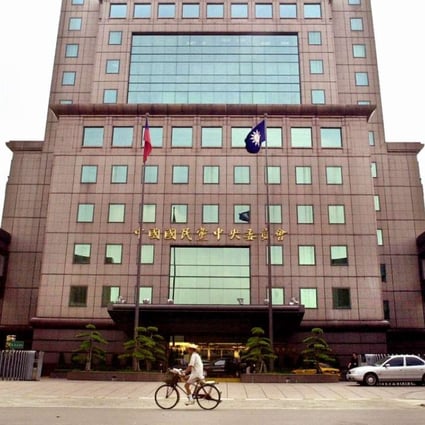A bicyclist rides past the Koumintang’s party headquarters in Taipei. Photo: AP