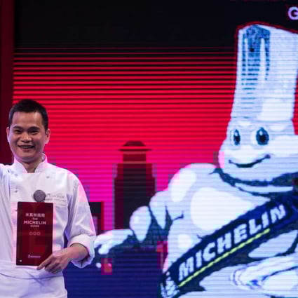 Master chef of T'ang Court Justin Tan reacts after the announcement the restaurant has been awarded three Michelin stars in the French company’s first guide to Shanghai dining. Photo: AFP