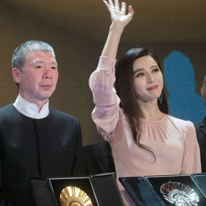 Chinese director Feng Xiaogang holds up the Concha de Oro (Golden Shell) award for best film alongside Chinese actress Fan Bingbing, holding the Concha de Plata (Silver Shell) for best actress at the San Sebastian Film Festival in Spain. Photo: Reuters