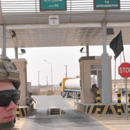 A US soldier stands guard near Afghanistan’s Shir Khan border crossing point with Tajikistan. Photo: SCMP Pictures