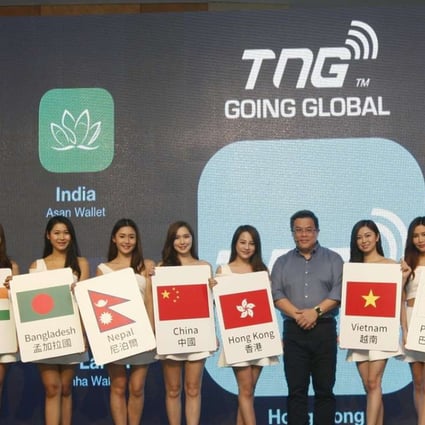 TNG Wallet founder and chief executive Alex Kong seen on Tuesday with models representing the different regions that the Hong Kong-based electronic wallet is now servicing. Photo: SCMP Pictures