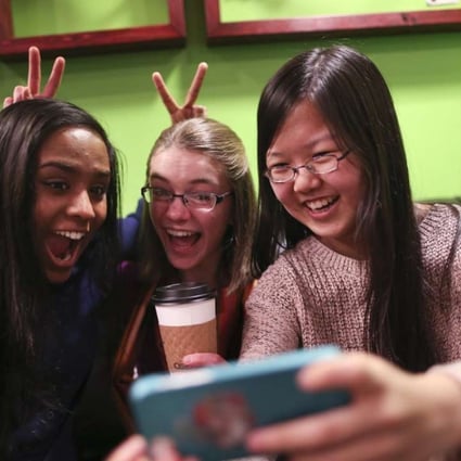 Friends Amrita Mohanty, 16, from left, Marta Williams, 16, and Michelle Mao, 15, take a Snapchat "selfie" while having coffee at the Steepery Tea Bar in Woodbury, Minn., Dec. 12, 2013. (Renee Jones Schneider/Minneapolis Star Tribune/MCT)