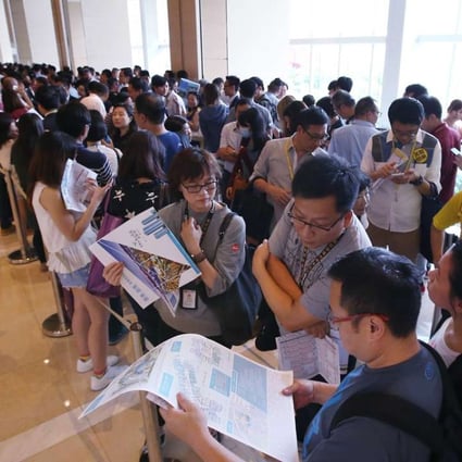 Flushed by easy money provided by finance companies that are upending the HKMA’s lending caps, property buyers throng a sales room. Photo: Felix Wong.