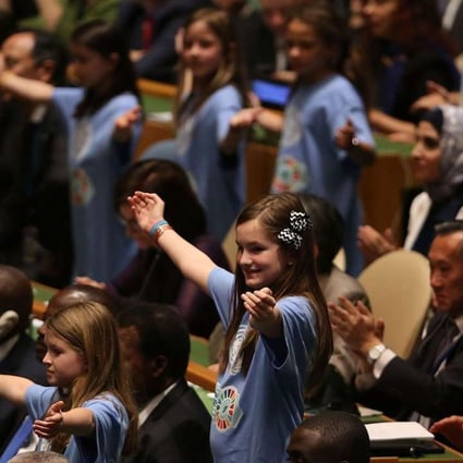 Children from around the world stand with leaders and country delegates in the General Assembly Hall at the UN signing ceremony for the Paris Agreement on April 22 in New York City. Photo: AFP