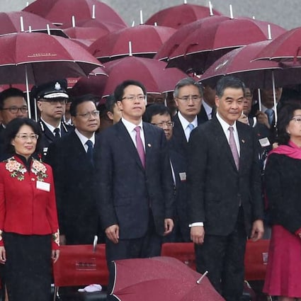 Hong Kong and Beijing officials attend a flag-raising ceremony on Saturday to celebrate National Day. From left: Major General Tan Benhong, head of the PLA’s Hong Kong garrison; Tong Xiaoling, acting commissioner of the Ministry of Foreign Affairs in Hong Kong; Zhang Xiaoming, director of the central government’s liaison office; Chief Executive Leung Chun-ying and his wife Regina Tong Ching-yi; and Chief Justice Geoffrey Ma Tao-li. Photo: Jonathan Wong