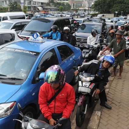 Commuters drive in heavy traffic in Jakarta. Photo: AFP