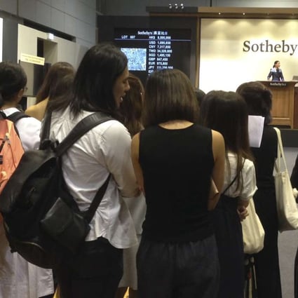 Fans of T.O.P. were allowed to watch the Sotheby’s auction co-curated by the K-pop star, having initially been denied entry to the sale room. Photo: Enid Tsui