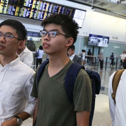 Joshua Wong (centre) arrives at Hong Kong International after being denied entry into Thailand. Photo: Sam Tsang