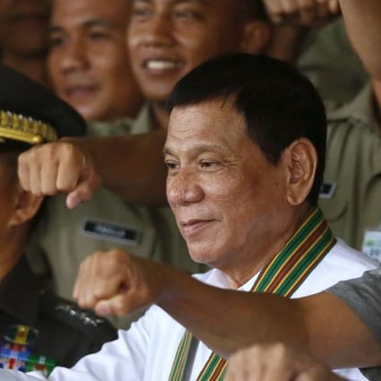 From left, Philippine Army chief Eduardo Ano, Philippine President Rodrigo Duterte, and National Defence chief Delfin Lorenzana, gesture with a fist bump as they pose with Philippine Army officers. Photo: AP