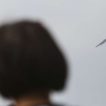 People gathered along Victoria Harbour to view the Boeing 747’s final flight on Saturday. Photo: Xiaomei Chen