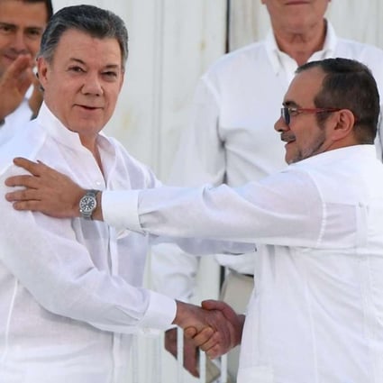 Colombian President Juan Manuel Santos (Left) and the head of the FARC guerrilla Timoleon Jimenez, aka Timochenko, shake hands during the signing of the historic peace agreement, days before the people of Colombia voted it down. Photo: Reuters