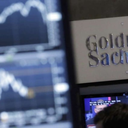 FILE - In this Oct. 16, 2014, file photo, a screen at a trading post on the floor of the New York Stock Exchange is juxtaposed with the Goldman Sachs booth. Goldman Sachs unveiled its long-awaited online consumer lending service called “Marcus” on Thursday, Oct. 13, 2016, the investment bank’s latest push to traditional retail banking products. Eligible customers will be able borrow up to $30,000 from Marcus as fixed-rate, no-fee, unsecured personal loans, with terms from two to six years. (AP Photo/Richard Drew, File)