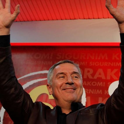 Montenegrin Prime Minister Milo Djukanovic waves to supporters after the parliamentary elections in Podgorica, Montenegro early Monday. Photo: Reuters