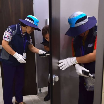 Members of Seoul hidden camera-hunting squad inspect a women's bathroom stall at a museum. Photo: AFP