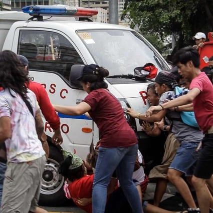 A police van runs over protesters during a protest in front of the US Embassy in Manila. Photo: EPA
