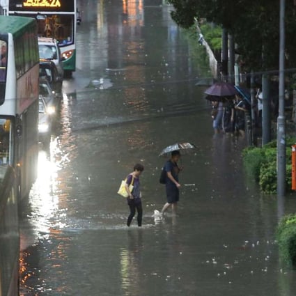People brave the flood in Causeway Bay. Photo: Sam Tsang