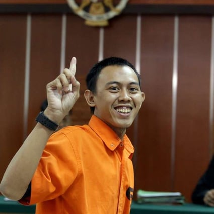 Indonesian militant Dodi Suridi, 23, smiles during his trial in Jakarta. Photo: EPA