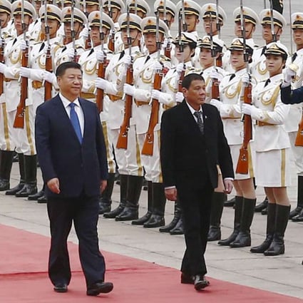 President Xi Jinping (left) and Philippine President Rodrigo Duterte heads for talks at the Great Hall of the People in beijing on Thursday. Photo: Kyodo